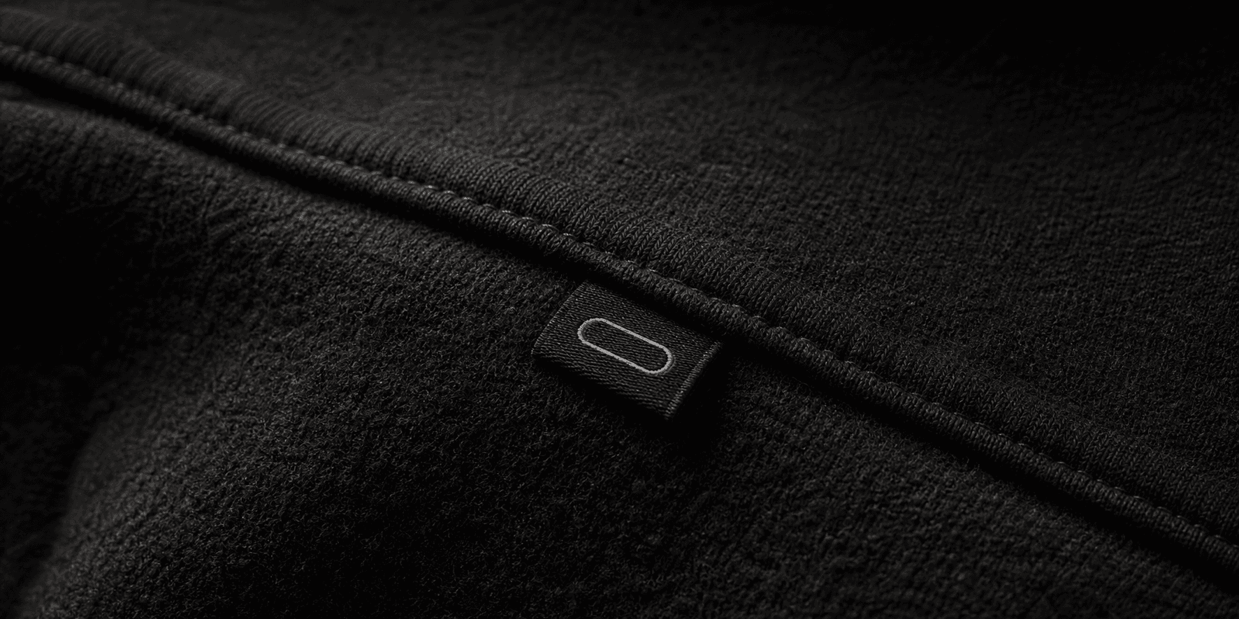 Close-up of heavyweight black fabric and garment label